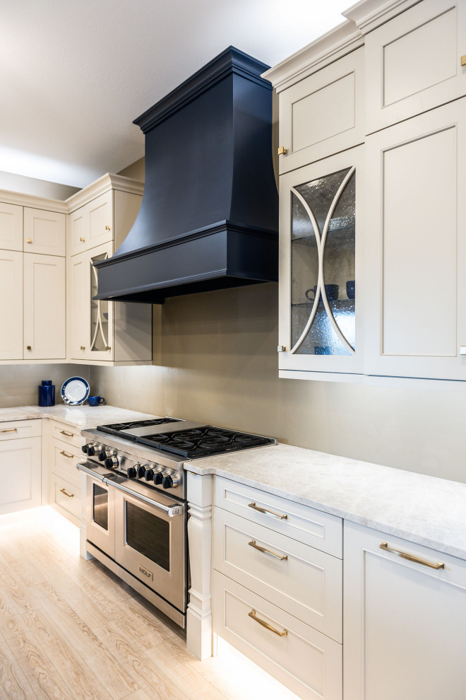 This is an example of a medium sized traditional l-shaped kitchen pantry in Other with a single-bowl sink, recessed-panel cabinets, white cabinets, quartz worktops, white splashback, ceramic splashback, stainless steel appliances, vinyl flooring, an island, beige floors and white worktops.