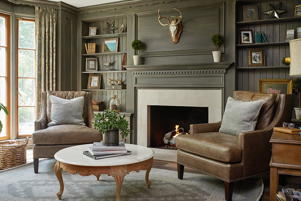 Photo of a large traditional family room in Grand Rapids with a library, grey walls, medium hardwood floors, a standard fireplace and a tile fireplace surround.