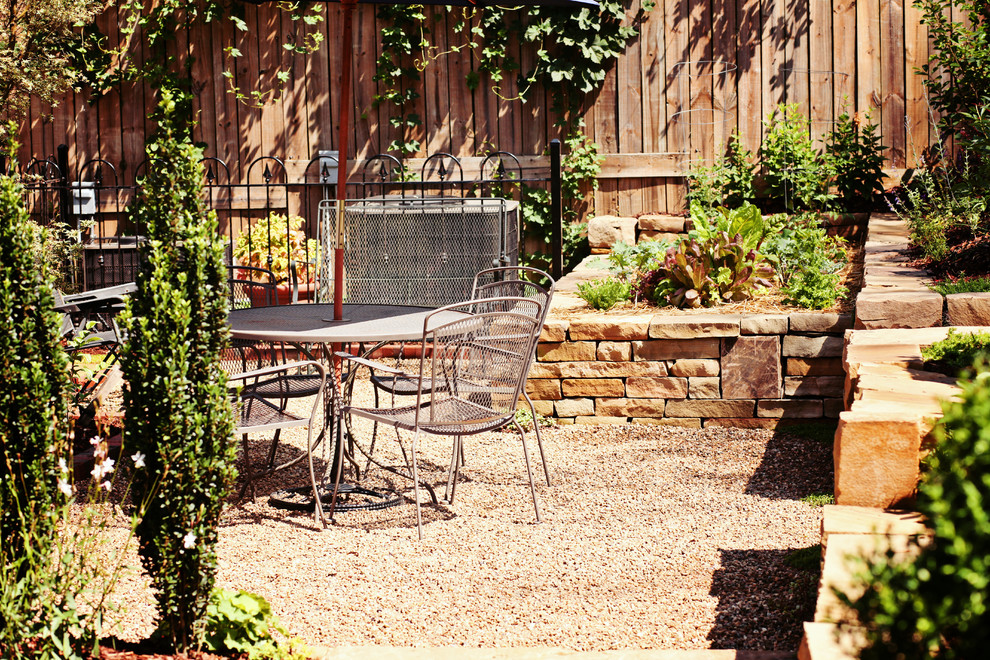 Small traditional backyard patio in Charlotte with a vegetable garden and gravel.