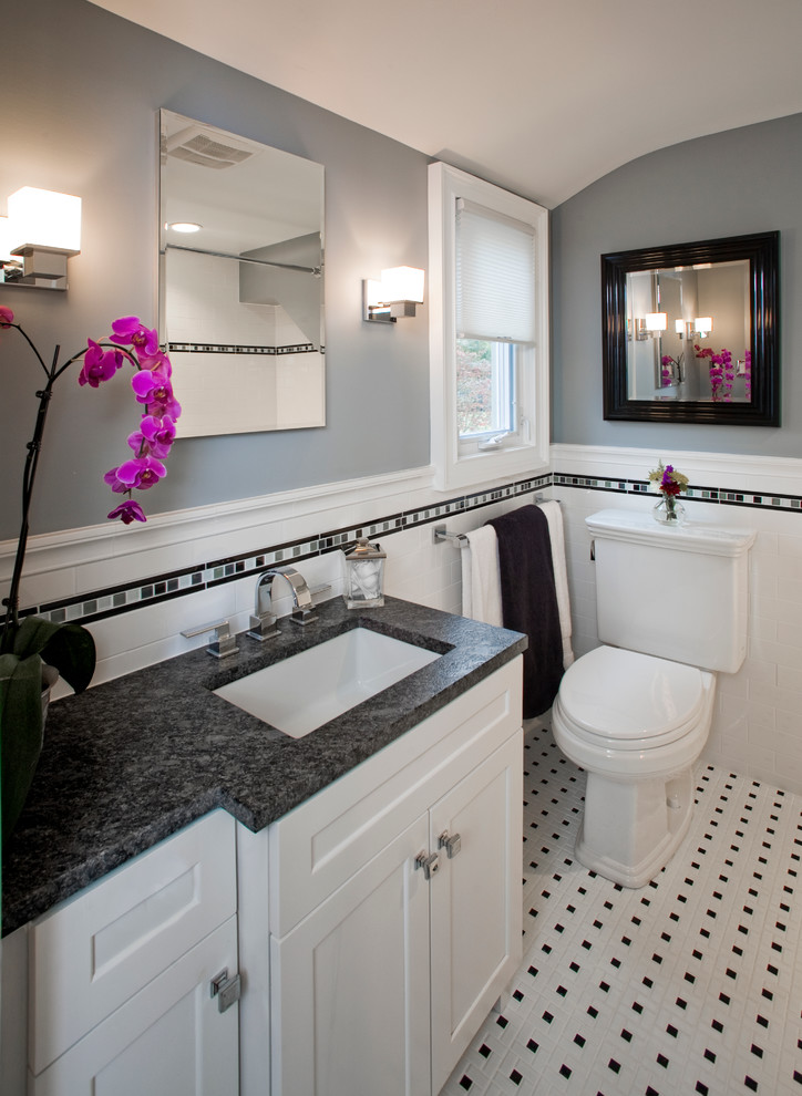Photo of a small transitional master bathroom in Philadelphia with an undermount sink, shaker cabinets, white cabinets, granite benchtops, an alcove tub, a shower/bathtub combo, a two-piece toilet, white tile, subway tile, porcelain floors, grey walls, multi-coloured floor and a shower curtain.