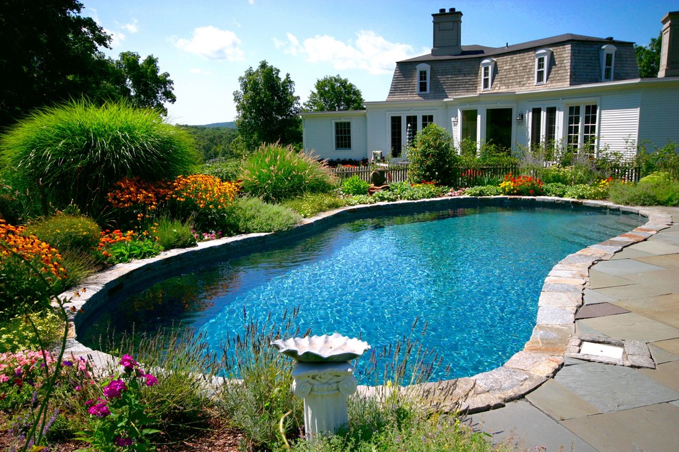 Pool - large rustic backyard stone and kidney-shaped natural pool idea in New York