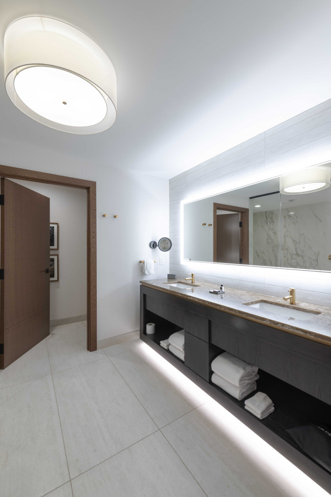 Photo of a large contemporary master bathroom in Minneapolis with black cabinets, a double shower, gray tile, porcelain tile, white walls, porcelain floors, grey floor, a hinged shower door, brown benchtops, a double vanity and a floating vanity.