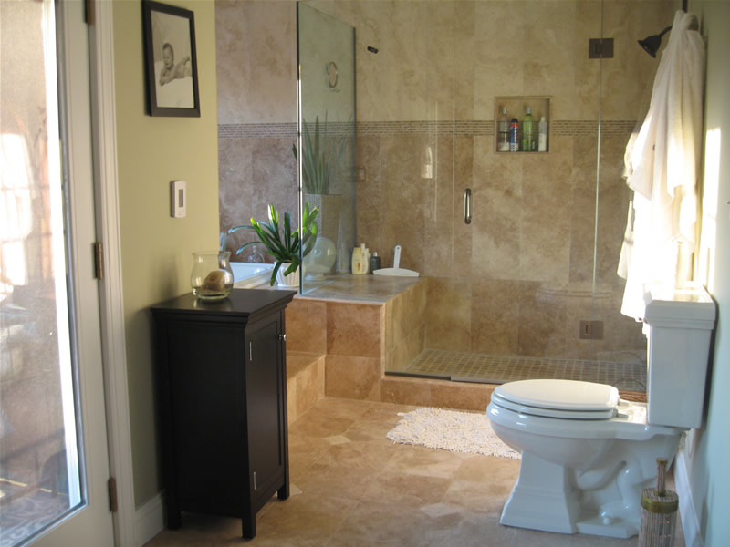 Design ideas for a mid-sized traditional master bathroom in Los Angeles with flat-panel cabinets, dark wood cabinets, beige tile, ceramic tile, a corner shower, a one-piece toilet, beige walls, ceramic floors, a drop-in sink and marble benchtops.