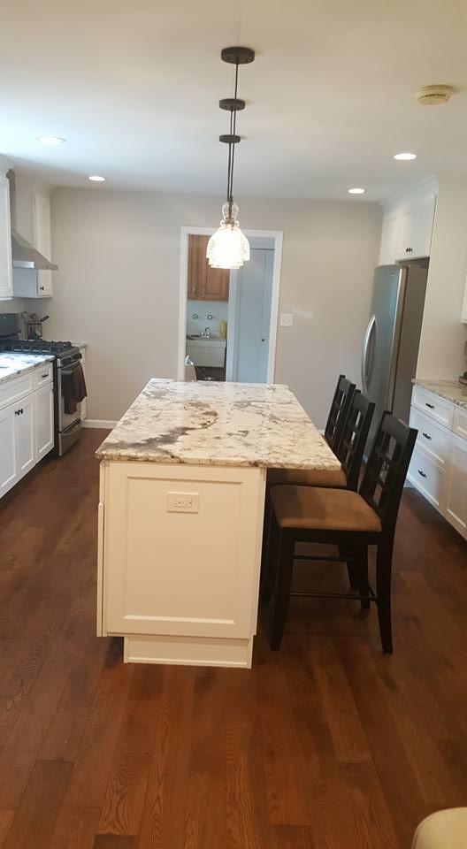 Inspiration for a large transitional u-shaped dark wood floor eat-in kitchen remodel in Baltimore with shaker cabinets, white cabinets, stainless steel appliances and an island