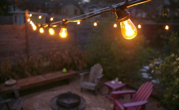 Design ideas for a transitional partial sun backyard landscaping with a fire pit.