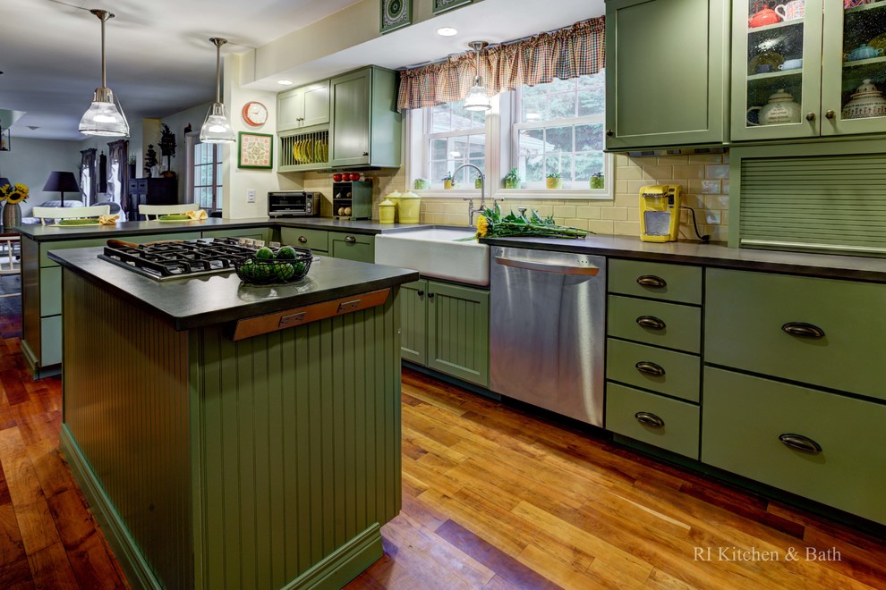 Inspiration for a large country u-shaped eat-in kitchen in Providence with a farmhouse sink, shaker cabinets, green cabinets, granite benchtops, yellow splashback, ceramic splashback, stainless steel appliances, medium hardwood floors and with island.