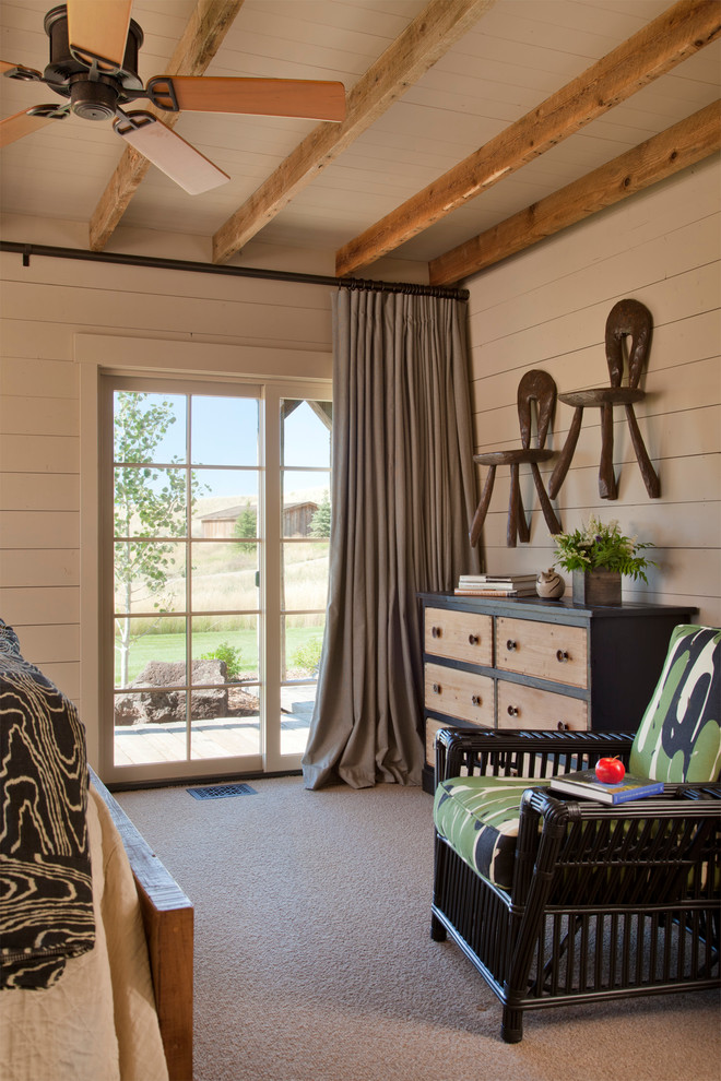 This is an example of a medium sized rustic guest bedroom in Other with beige walls, carpet, beige floors, exposed beams and tongue and groove walls.