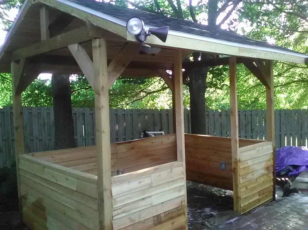 Photo of a small rustic full sun backyard stone landscaping for summer.