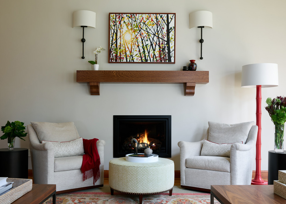 Inspiration for a huge transitional open concept medium tone wood floor and brown floor living room remodel in Boston with gray walls, a standard fireplace, a metal fireplace and a media wall