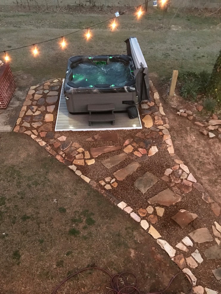 Example of a mid-sized transitional backyard stone and rectangular hot tub design