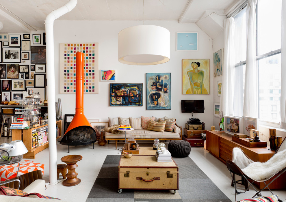 This is an example of an eclectic living room in New York with white walls and a wood stove.