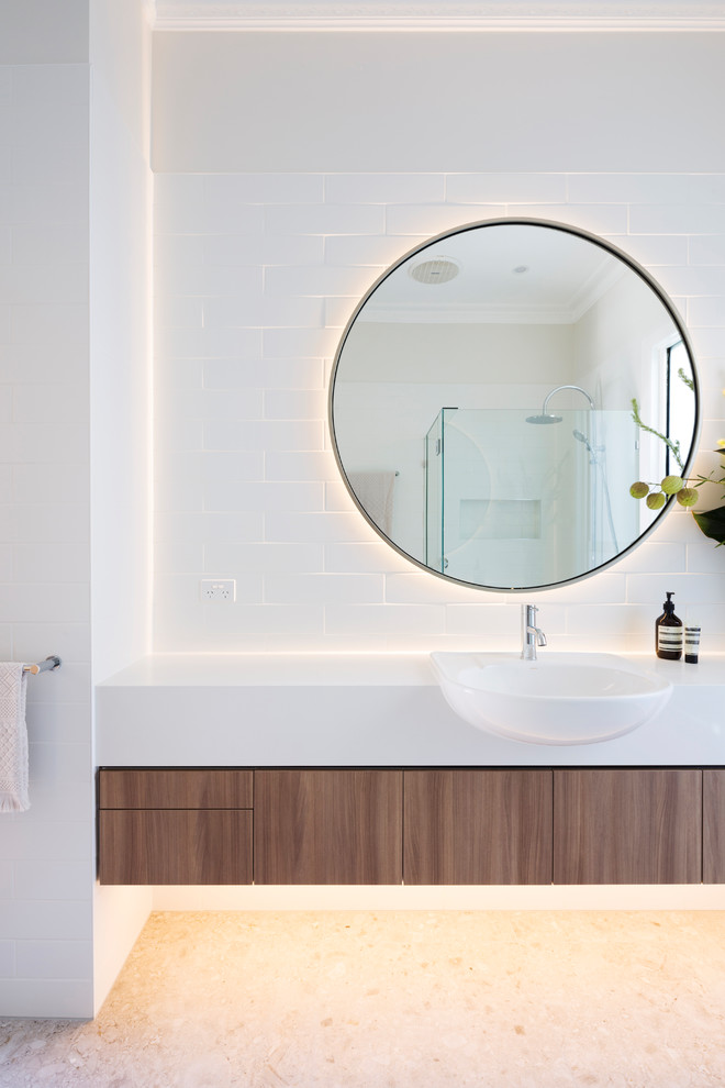 Inspiration for a mid-sized contemporary 3/4 bathroom in Melbourne with medium wood cabinets, white tile, porcelain tile, white walls, porcelain floors, engineered quartz benchtops, beige floor, a hinged shower door and white benchtops.