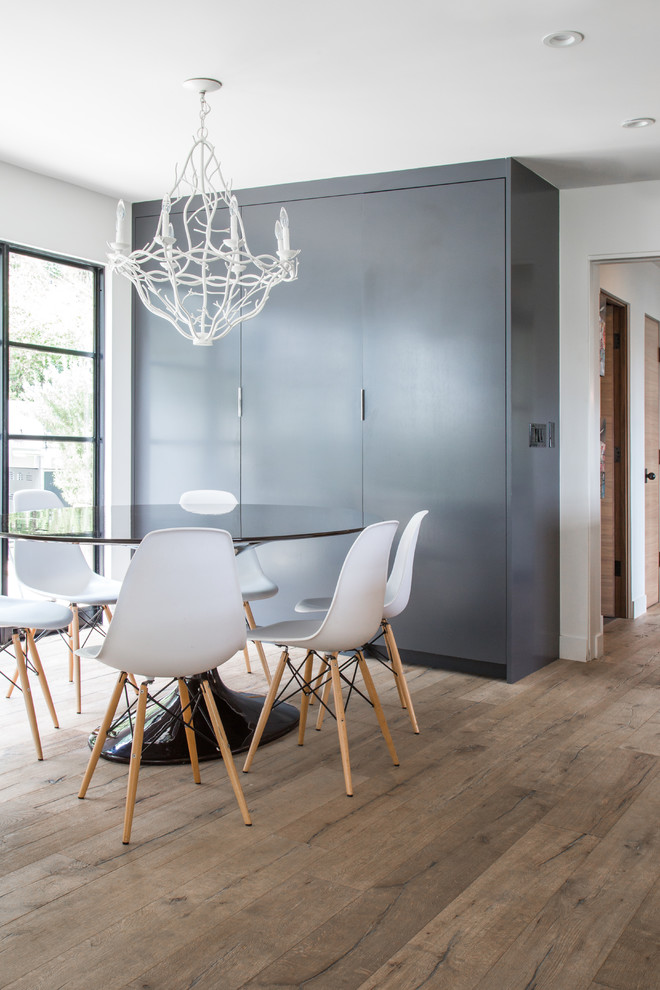 Contemporary dining room in Los Angeles with white walls and medium hardwood floors.