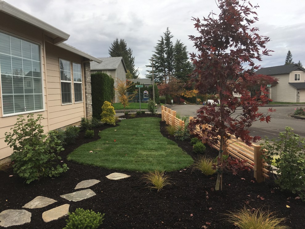 This is an example of a mid-sized asian front yard formal garden in Portland with natural stone pavers.