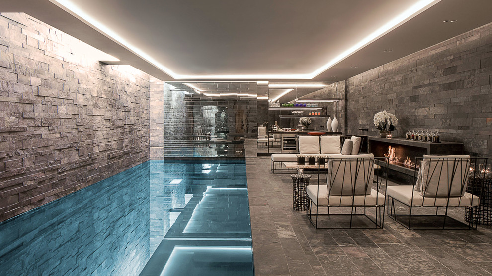Photo of a mid-sized transitional indoor rectangular pool in London.