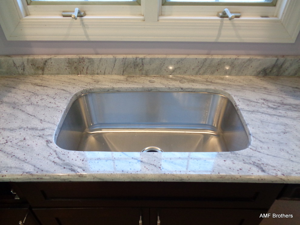 Inspiration for a modern kitchen in Chicago with a double-bowl sink and granite benchtops.