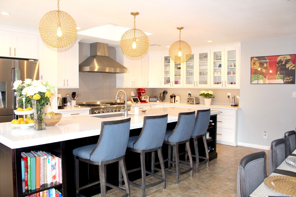 Inspiration for a large transitional l-shaped ceramic tile and beige floor open concept kitchen remodel in Phoenix with an undermount sink, shaker cabinets, white cabinets, quartzite countertops, gray backsplash, stainless steel appliances and an island