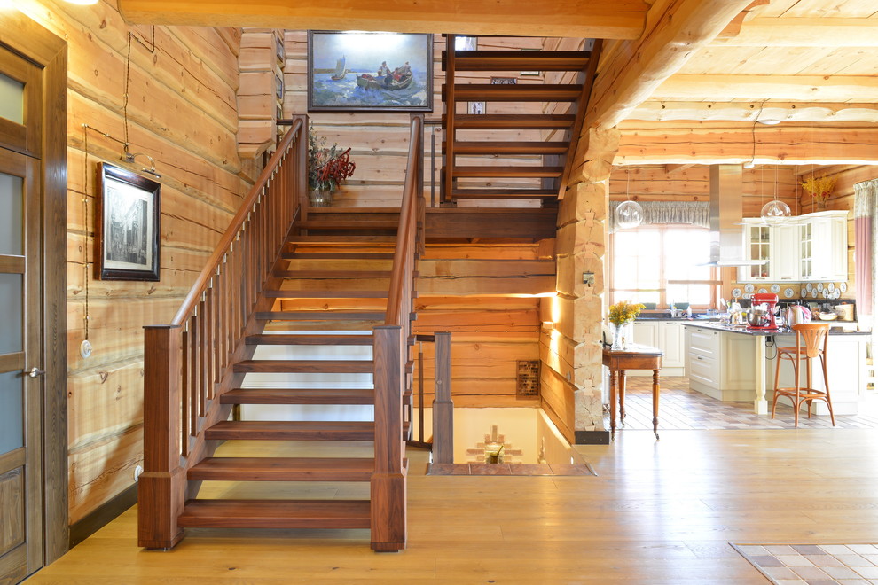 Design ideas for a large country wood u-shaped staircase in Moscow with open risers.