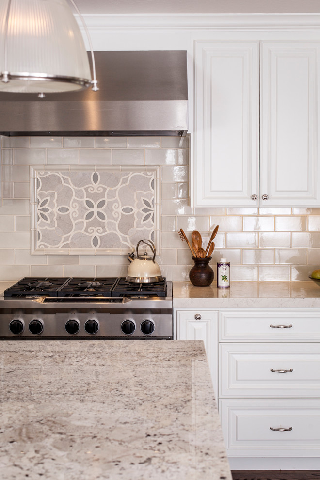 Inspiration for a large transitional l-shaped kitchen in San Francisco with a farmhouse sink, beaded inset cabinets, white cabinets, granite benchtops, white splashback, porcelain splashback, stainless steel appliances, medium hardwood floors and with island.