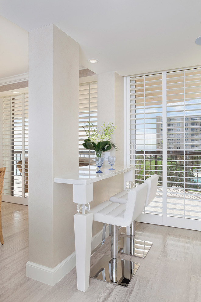 Example of a mid-sized transitional light wood floor and beige floor eat-in kitchen design in Miami with marble countertops, an island and white countertops
