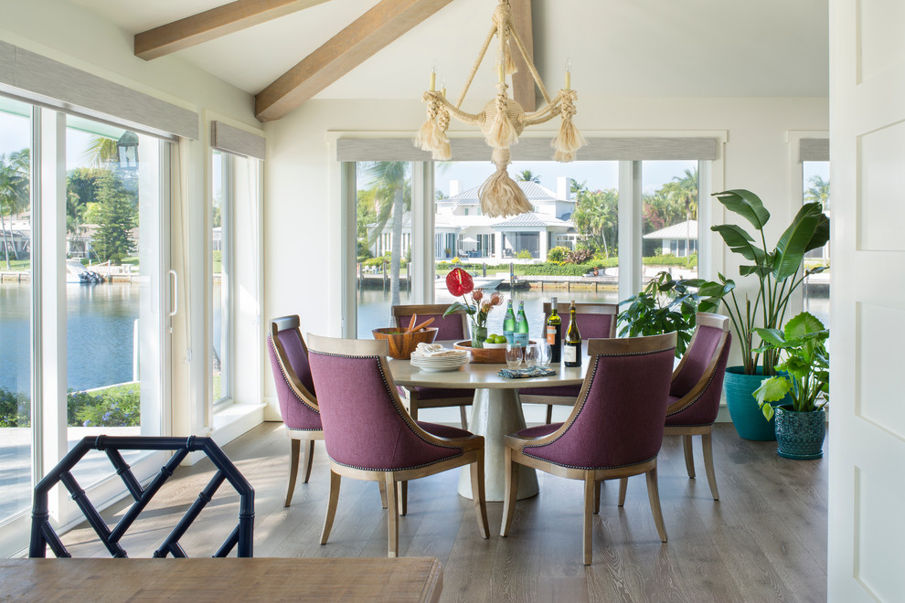 Mid-sized beach style dining room in Miami with white walls, no fireplace and light hardwood floors.