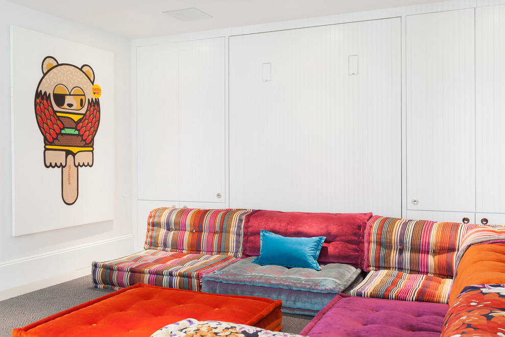 Photo of a beach style gender-neutral kids' playroom in Boston with white walls and carpet.