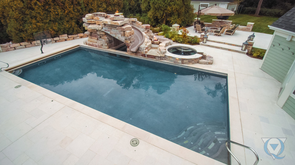 Large mountain style backyard rectangular lap water slide photo in Chicago