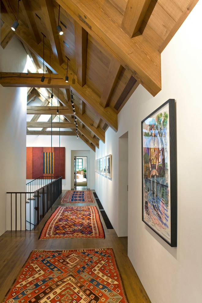 Transitional hallway in Seattle with white walls and light hardwood floors.