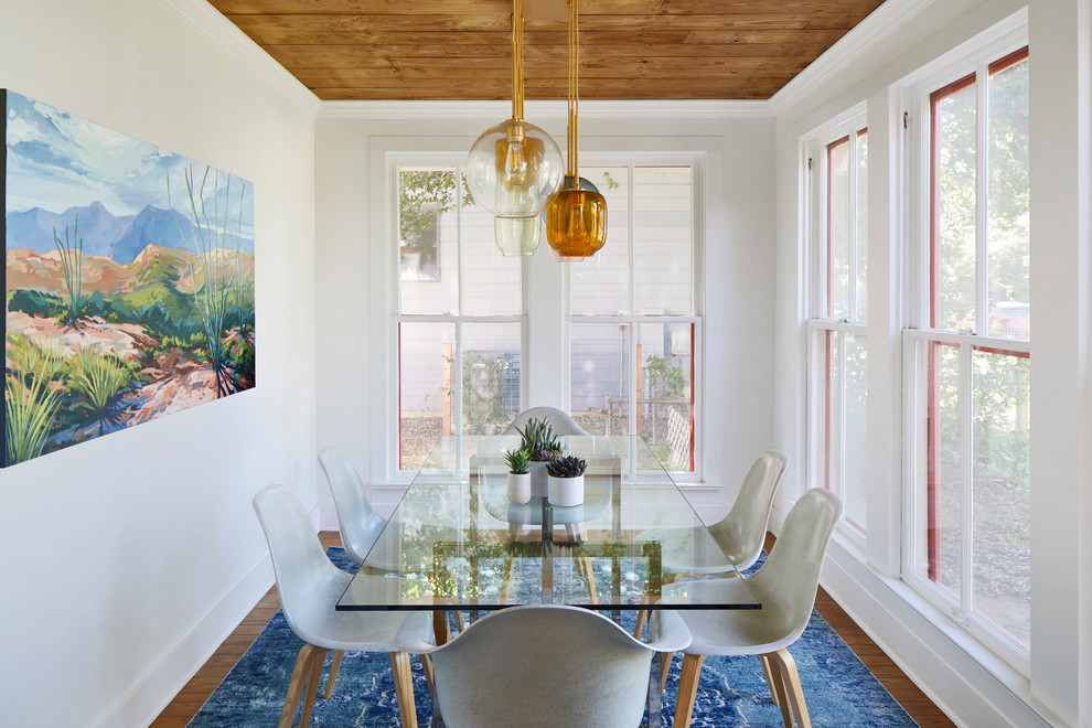 Inspiration for a mid-sized eclectic medium tone wood floor and brown floor enclosed dining room remodel in Austin with white walls and no fireplace