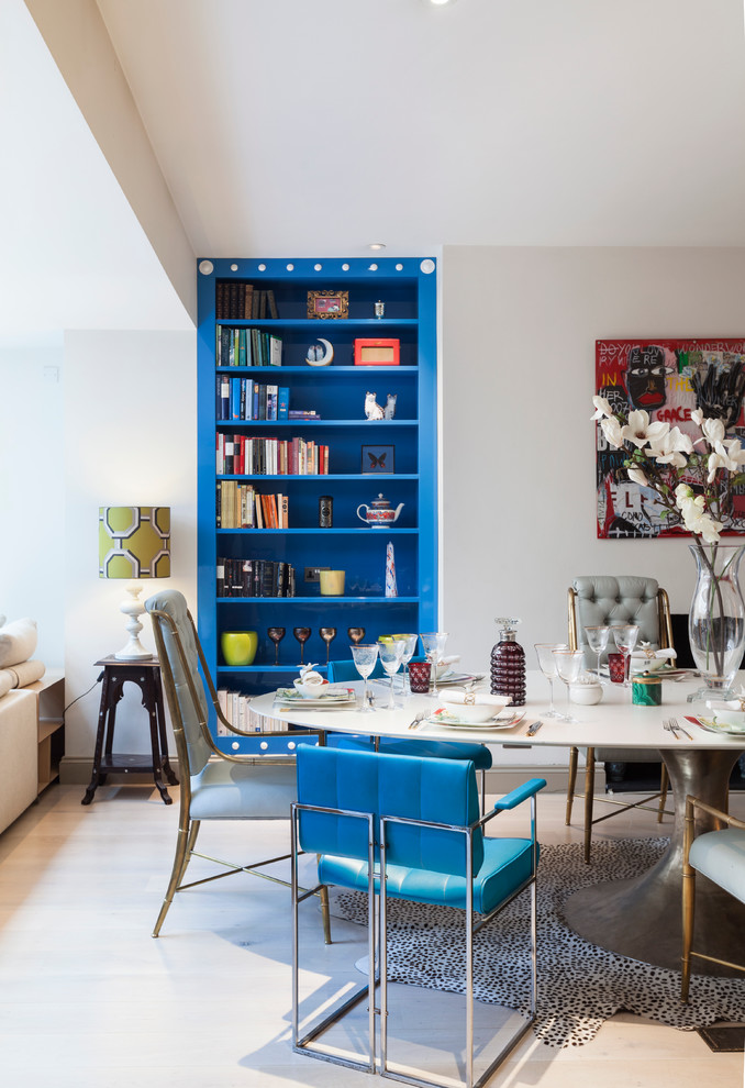 This is an example of a mid-sized eclectic open plan dining in London with grey walls and light hardwood floors.