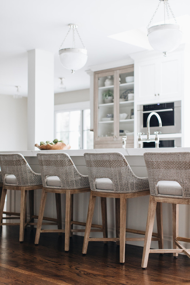 Eat-in kitchen - mid-sized transitional dark wood floor and brown floor eat-in kitchen idea in Chicago with a farmhouse sink, beaded inset cabinets, white cabinets, quartz countertops, paneled appliances, an island and white countertops