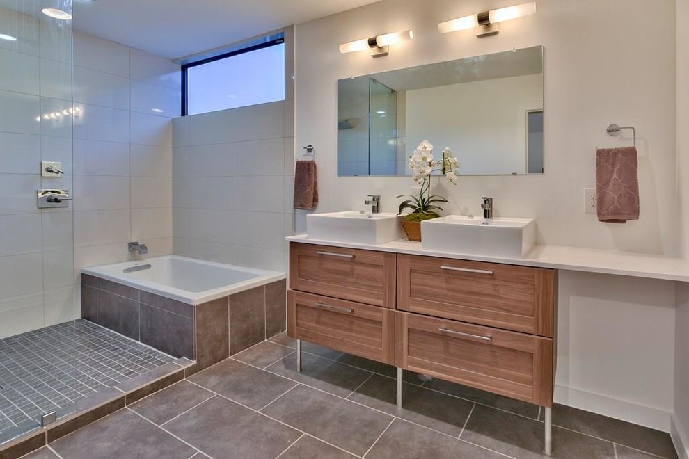 Mid-sized contemporary master bathroom in Austin with shaker cabinets, light wood cabinets, a corner tub, a corner shower, white tile, porcelain tile, beige walls, slate floors, a drop-in sink, engineered quartz benchtops, grey floor and an open shower.