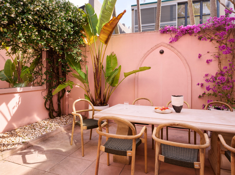 This is an example of a tropical patio in Sydney with no cover.