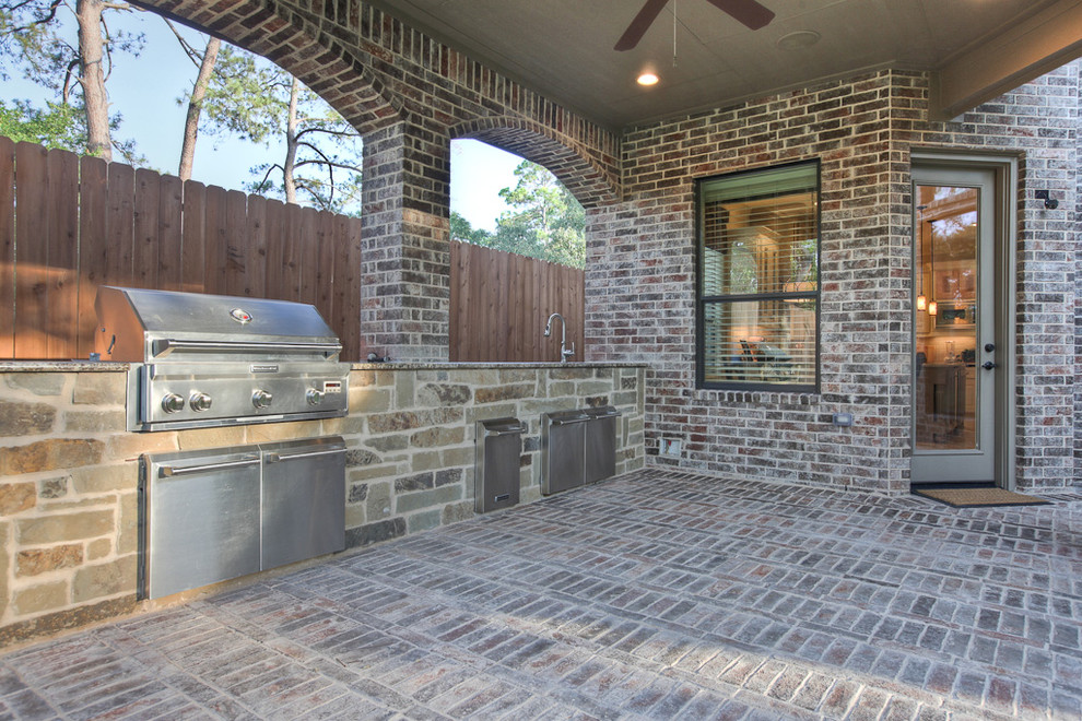 Design ideas for a traditional backyard patio in Houston with an outdoor kitchen.