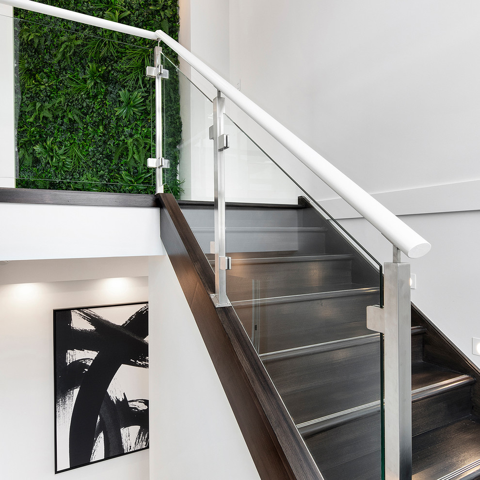 Mid-sized modern wood straight staircase in Wollongong with wood risers and metal railing.
