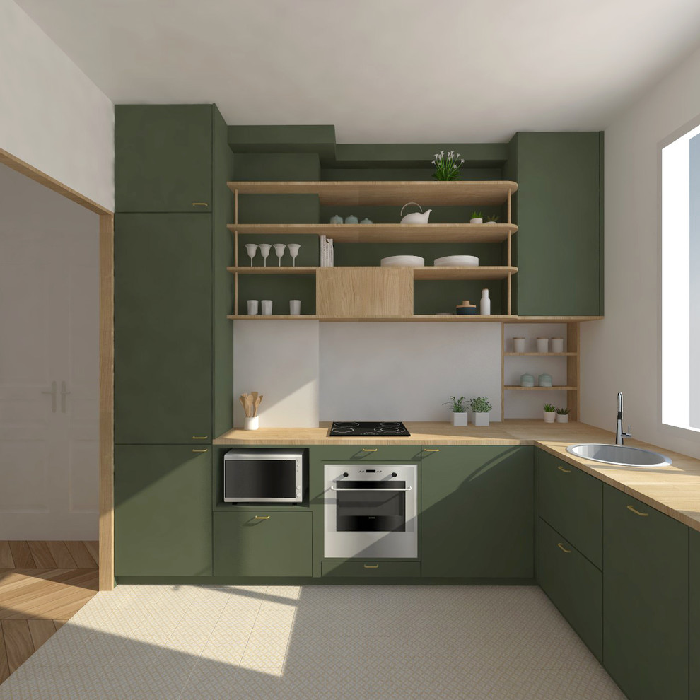This is an example of a mid-sized contemporary l-shaped separate kitchen in Le Havre with an undermount sink, beaded inset cabinets, green cabinets, wood benchtops, stainless steel appliances, beige benchtop and concrete floors.