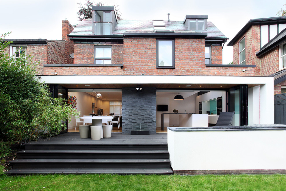 Inspiration for a mid-sized contemporary two-storey brick exterior in Manchester with a hip roof.