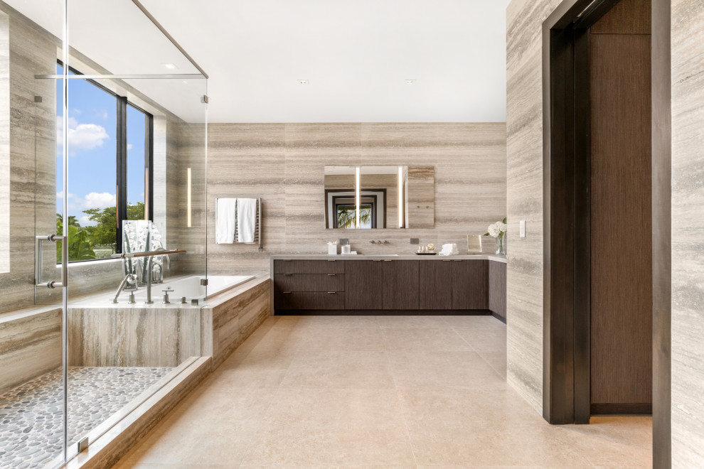 Inspiration for a large contemporary master bathroom in Miami with flat-panel cabinets, dark wood cabinets, a drop-in tub, a corner shower, beige tile, an undermount sink, beige floor, a hinged shower door, grey benchtops, a single vanity and a built-in vanity.