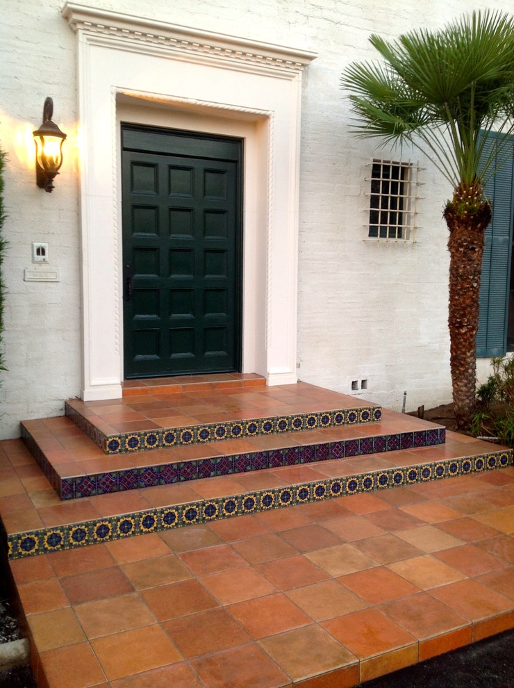 Design ideas for a large mediterranean front door in Los Angeles with white walls, a single front door and a black front door.