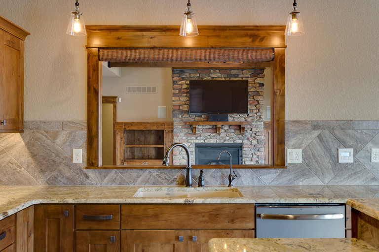 Eat-in kitchen - rustic u-shaped eat-in kitchen idea with an undermount sink, shaker cabinets and an island