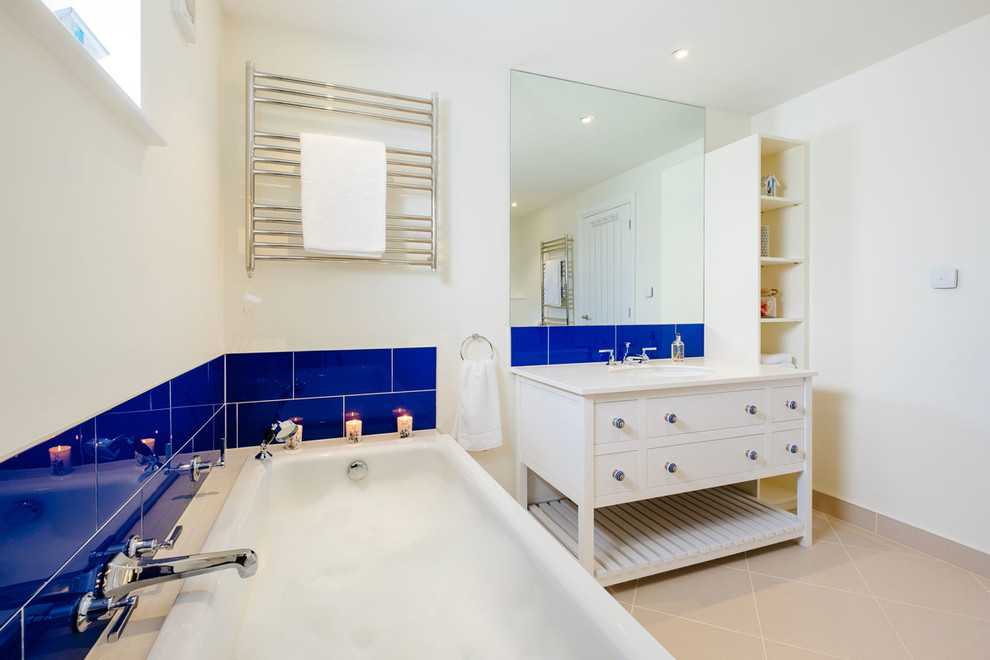 This is an example of a mid-sized beach style kids bathroom in Cornwall with shaker cabinets, white cabinets and a freestanding vanity.