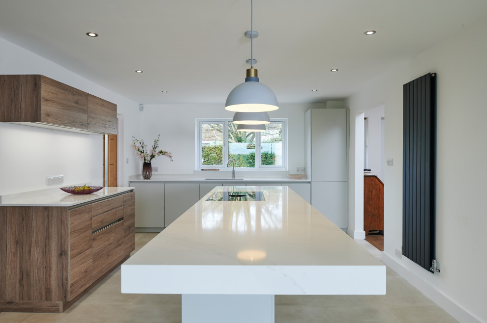 Photo of a medium sized contemporary open plan kitchen in Other with flat-panel cabinets, grey cabinets, quartz worktops, an island and white worktops.