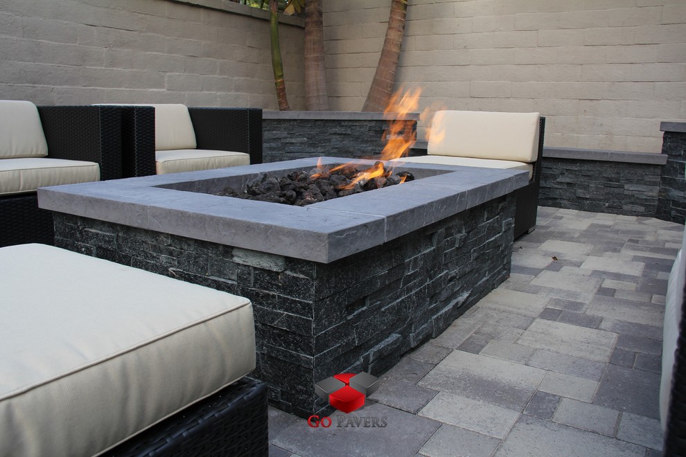 Small contemporary backyard patio in Los Angeles with a fire feature and concrete pavers.