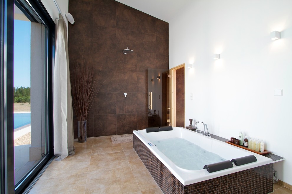 Large contemporary master bathroom in London with brown tile, mosaic tile, white walls, a hot tub, an open shower and travertine floors.