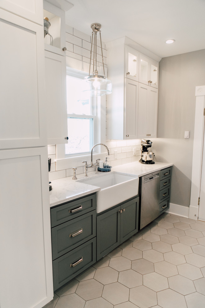 Inspiration for a small country galley porcelain tile and gray floor enclosed kitchen remodel in Seattle with a farmhouse sink, shaker cabinets, gray cabinets, quartz countertops, white backsplash, ceramic backsplash, stainless steel appliances and white countertops