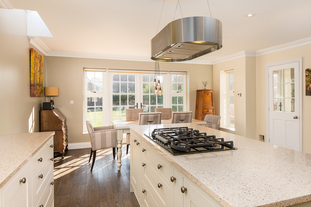 Medium sized classic u-shaped kitchen/diner in Berkshire with a submerged sink, shaker cabinets, white cabinets, quartz worktops, metallic splashback, mosaic tiled splashback, integrated appliances, dark hardwood flooring, an island, brown floors and beige worktops.