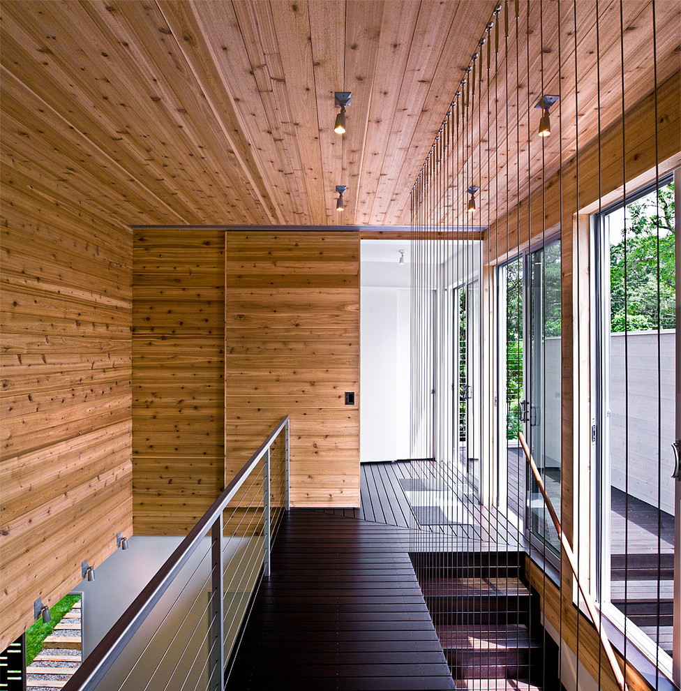 Design ideas for a modern hallway in New York with dark hardwood floors and black floor.