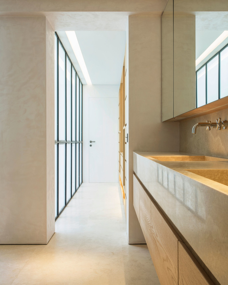 Modelo de aseo contemporáneo de tamaño medio con armarios con paneles lisos, puertas de armario de madera oscura, paredes grises, suelo de cemento y suelo gris