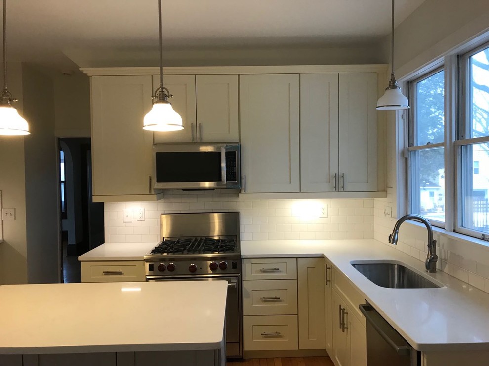 Huge minimalist l-shaped kitchen pantry photo with shaker cabinets and white cabinets