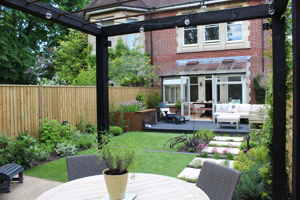 Design ideas for a small contemporary backyard partial sun formal garden for summer in Hampshire with decking.